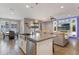 Open concept kitchen, dining and living space with stainless appliances, pendant lighting, and sleek design at 15443 Sugarcup Ct, Orlando, FL 32828