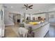 The open-concept living room is adjacent to the modern kitchen and stairway at 15443 Sugarcup Ct, Orlando, FL 32828