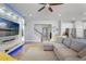 Comfortable living room featuring a modern entertainment center, an arched entryway, and an adjacent stairway at 15443 Sugarcup Ct, Orlando, FL 32828