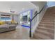 Comfortable living room with an entertainment center, sectional sofa, and carpeted stairs at 15443 Sugarcup Ct, Orlando, FL 32828