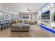 Open concept living room with stylish sectional sofa, breakfast bar, and entertainment center at 15443 Sugarcup Ct, Orlando, FL 32828