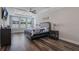 Main bedroom with wood floors features tray ceiling, fan, shutters, and modern decor at 15443 Sugarcup Ct, Orlando, FL 32828