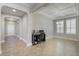 Neutral room with tile floor, an office desk, and lots of light from the front door at 15443 Sugarcup Ct, Orlando, FL 32828