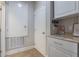 A white pantry with shaker cabinets and granite counters showcases handy storage solutions at 15443 Sugarcup Ct, Orlando, FL 32828