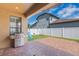 A covered patio with a grill overlooks the fenced backyard with a playset at 15443 Sugarcup Ct, Orlando, FL 32828
