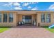 A covered patio with chairs and a grill offers a relaxing outdoor space at 15443 Sugarcup Ct, Orlando, FL 32828