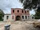 Two-story home under construction featuring a unique arched entryway and a detached two car garage at 185 Sylvan Blvd, Winter Park, FL 32789