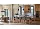 Gourmet kitchen featuring an island with seating, a custom range hood, and stainless steel appliances at 185 Sylvan Blvd, Winter Park, FL 32789