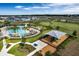 Aerial view of community amenities, including a zero entry pool with splash pad and a shaded playground at 1880 Perch Hammock Loop, Groveland, FL 34736
