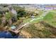 Aerial view of a community park with a pier, picnic shelter, walking paths, and scenic landscaping at 1880 Perch Hammock Loop, Groveland, FL 34736