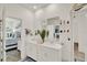 Bright bathroom features a double sink vanity with white cabinets, linen closet and view to bedroom at 1880 Perch Hammock Loop, Groveland, FL 34736