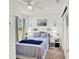 Cozy bedroom featuring a bed, natural light, and calming decor at 1880 Perch Hammock Loop, Groveland, FL 34736