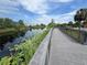 A boardwalk meanders through a serene wetland area with lush vegetation and a tranquil waterway at 1880 Perch Hammock Loop, Groveland, FL 34736