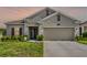 Charming single-Gathering home featuring a well-maintained lawn and a welcoming two-car garage at 1880 Perch Hammock Loop, Groveland, FL 34736