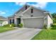 Charming single-story home featuring a two-car garage, well-maintained lawn, and neutral paint at 1880 Perch Hammock Loop, Groveland, FL 34736
