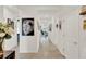 Bright hallway featuring neutral walls, ceramic tile flooring, and access to other living spaces at 1880 Perch Hammock Loop, Groveland, FL 34736