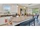 Spacious kitchen with an island bench, stainless steel appliances, and a window view at 1880 Perch Hammock Loop, Groveland, FL 34736