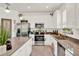 Kitchen featuring stainless steel appliances, white cabinets, ample counter space, and modern fixtures at 1880 Perch Hammock Loop, Groveland, FL 34736