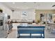 Bright kitchen featuring white cabinets, stainless steel appliances, and a spacious island perfect for meal preparation at 1880 Perch Hammock Loop, Groveland, FL 34736