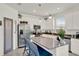 Modern kitchen with stainless steel appliances, white cabinetry, and a pantry door for added convenience at 1880 Perch Hammock Loop, Groveland, FL 34736