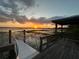 Picturesque sunset view from the deck over the lake, creating a serene and tranquil atmosphere for relaxation and enjoyment at 1880 Perch Hammock Loop, Groveland, FL 34736