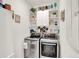 Organized laundry room with shelving, storage, and modern washer and dryer at 1880 Perch Hammock Loop, Groveland, FL 34736