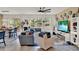 Bright living room featuring tile flooring, a ceiling fan and stylish decor with natural light and comfortable seating at 1880 Perch Hammock Loop, Groveland, FL 34736