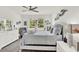Primary bedroom with natural light, a ceiling fan, and decorative accents for a cozy and inviting ambiance at 1880 Perch Hammock Loop, Groveland, FL 34736