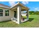 Covered patio with seating area overlooks the backyard, great for outdoor entertaining at 1880 Perch Hammock Loop, Groveland, FL 34736