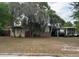 Single-story home featuring a carport, neutral color palette, brick accents, and a spacious front yard at 1909 Edwin Blvd, Winter Park, FL 32792
