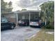 A single-story home featuring a carport and a traditional design with mature landscaping at 1909 Edwin Blvd, Winter Park, FL 32792