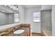 Bathroom vanity featuring a stylish mosaic backsplash, granite counters, and modern fixtures at 1965 Greenview Dr, Deltona, FL 32725