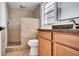 Bathroom featuring tiled shower, vanity with granite counters, and modern fixtures at 1965 Greenview Dr, Deltona, FL 32725