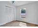 Cozy bedroom featuring tiled floors, closet space, and a window for natural light at 1965 Greenview Dr, Deltona, FL 32725