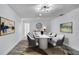 A stylish formal dining room features modern lighting, neutral paint, and updated flooring at 1965 Greenview Dr, Deltona, FL 32725