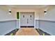 A close up of a freshly painted gray front door with updated fixtures at 1965 Greenview Dr, Deltona, FL 32725