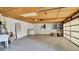 A spacious garage with bright, sealed concrete floors, washer, dryer, utility sink, and ceiling mounted storage at 1965 Greenview Dr, Deltona, FL 32725