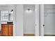 Hallway leading to bathroom vanity with granite counters, tiled shower, and modern fixtures at 1965 Greenview Dr, Deltona, FL 32725