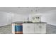 Island kitchen featuring white cabinets, granite countertops and a modern design at 1965 Greenview Dr, Deltona, FL 32725