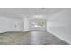 Bright living room with wood-look tile floors and a large window at 1965 Greenview Dr, Deltona, FL 32725