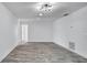 Open room with neutral paint, modern lighting, and updated flooring at 1965 Greenview Dr, Deltona, FL 32725