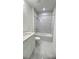 Modern bathroom featuring a tub with shower, marble tile, and contemporary vanity at 2009 Stone Wall Ct, Lake Hamilton, FL 33851