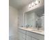 Bathroom featuring double sinks, modern lighting, and a large mirror at 2009 Stone Wall Ct, Lake Hamilton, FL 33851