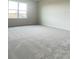 Neutral bedroom featuring a large window and plush neutral carpeting at 2009 Stone Wall Ct, Lake Hamilton, FL 33851