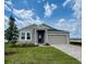 Beautiful one-story home with gray stucco, manicured lawn, and paver driveway to a two car garage at 2009 Stone Wall Ct, Lake Hamilton, FL 33851