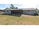 This property features a spacious backyard with a screened-in lanai attached to the house at 2102 Urbana Ave, Deltona, FL 32725