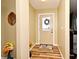 Welcoming entryway with wood-look flooring, a decorative wreath, and neutral paint, offering a warm welcome at 2102 Urbana Ave, Deltona, FL 32725