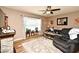 Cozy living room featuring a stone fireplace, large bay window, and comfortable seating at 2102 Urbana Ave, Deltona, FL 32725