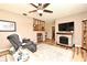 Comfortable living room showcasing a stone fireplace, ceiling fan, and neutral decor for relaxed living at 2102 Urbana Ave, Deltona, FL 32725