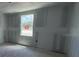 This room features unfinished walls ready for painting and a bright window illuminating the spacious area at 22113 Amberbush Ct., Mount Dora, FL 32757